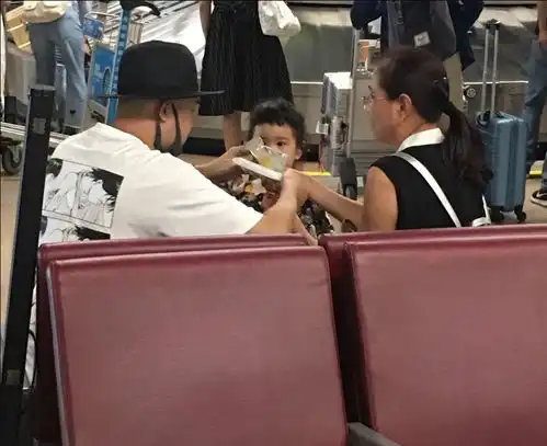 包贝尔带女儿现身机场包可艾穿图案印花裙子宛如公主表情呆萌